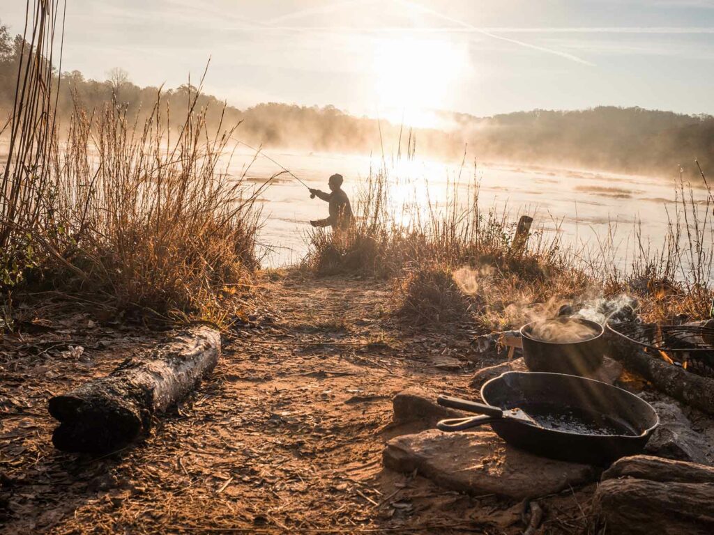 A fisherman fishes in the Chattahoochee River. 