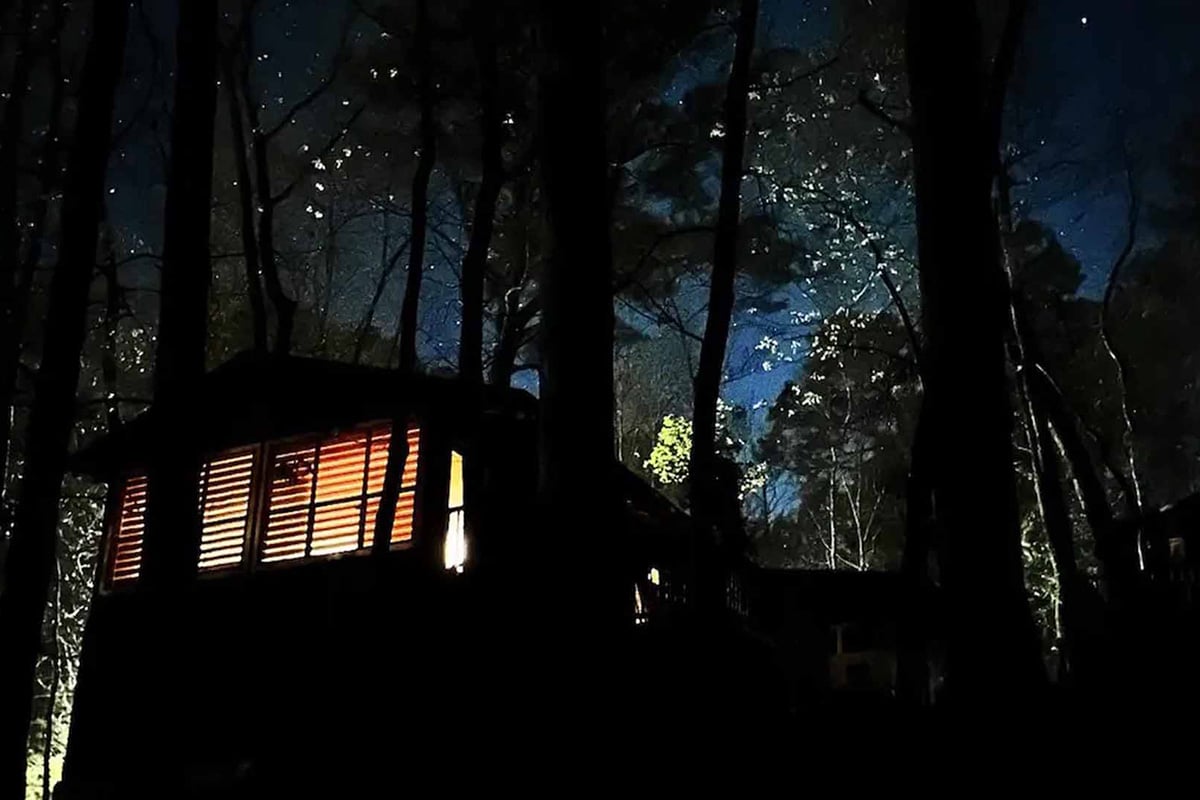 Peaceful cabin in the woods at night.