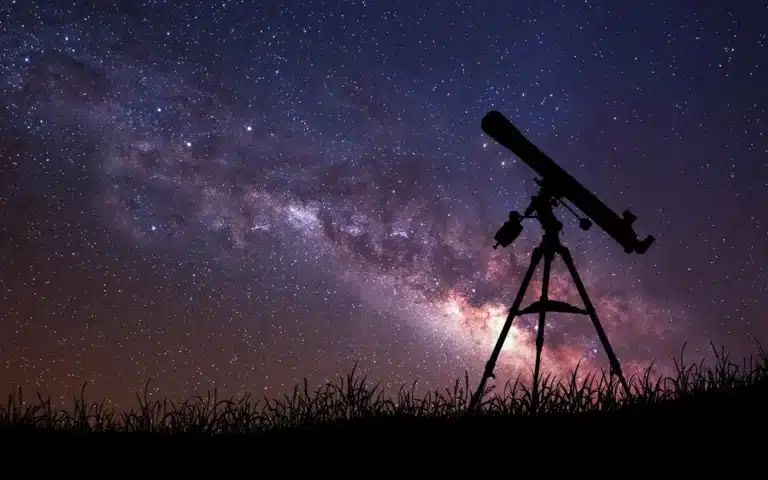 A telescope is set up to view the night sky.